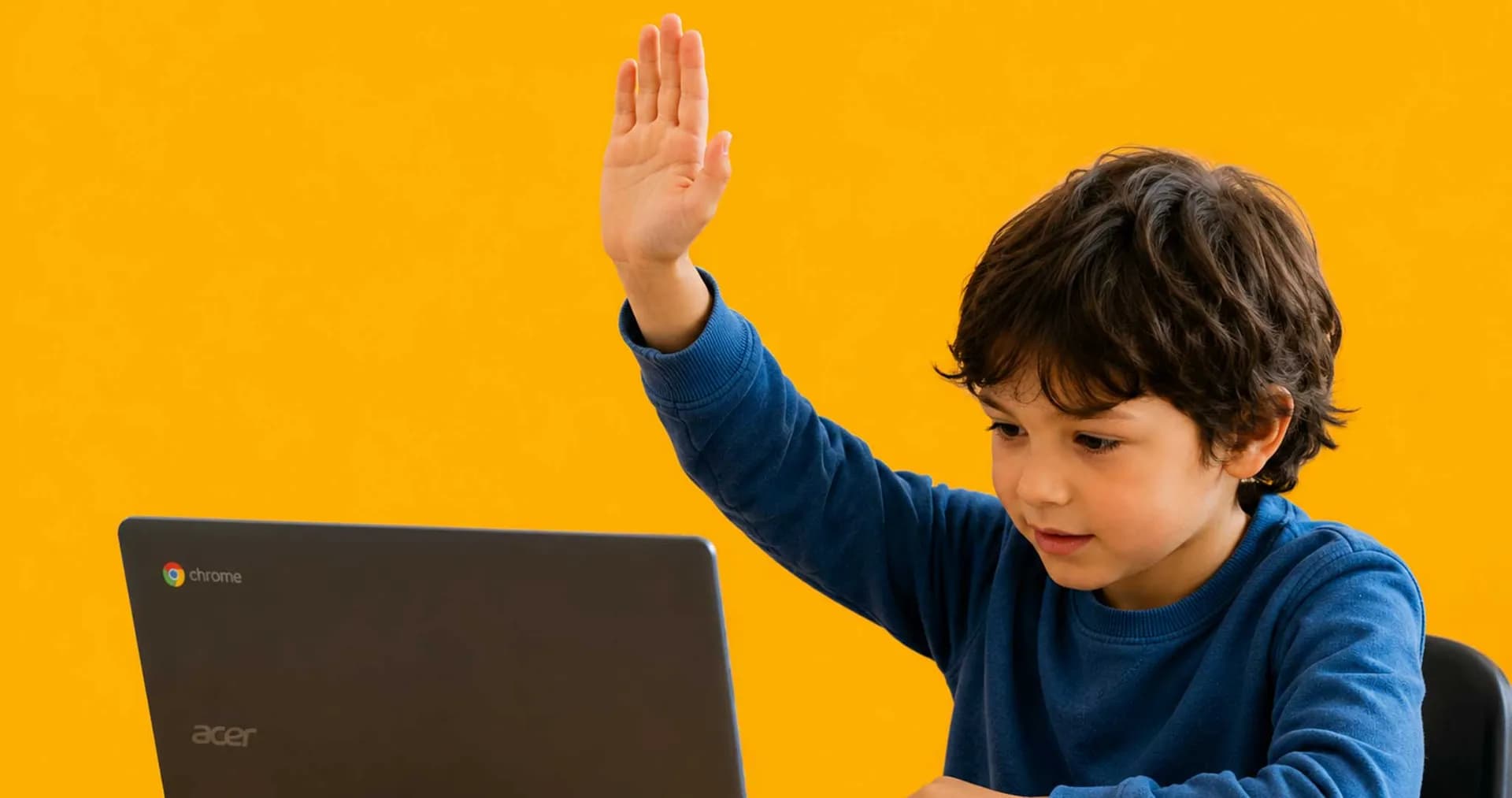 child sitting at computer raising their hand