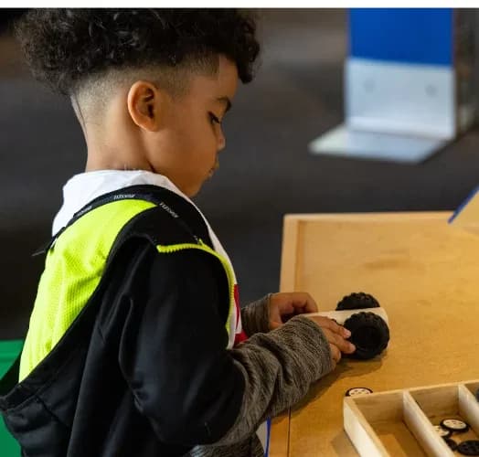 A young student working on a hands-on activity